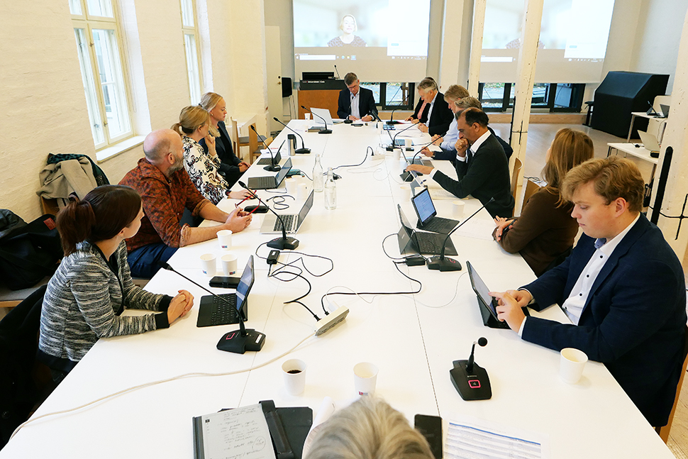Fleire personar sit rundt eit langbord